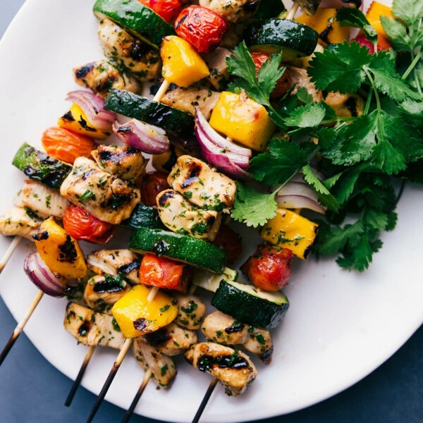 Gorgeous, vibrant chicken kabobs on a plate, grilled, and ready to eat.