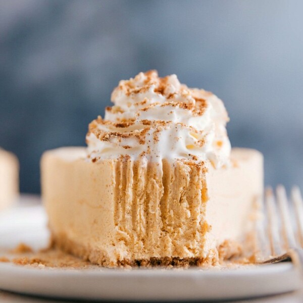 Slice of cheesecake with a missing bite, showcasing its creamy goodness.