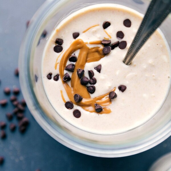 Finished peanut butter cheesecake overnight oats, adorned with a gorgeous peanut butter swirl and chocolate chips on top.