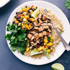 Delicious quinoa chicken bowl with fresh mango salsa and cilantro on the side.