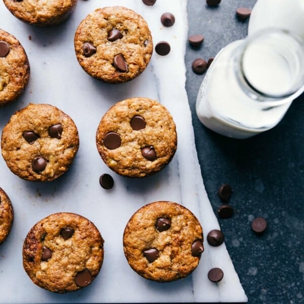 Warm peanut butter banana muffins topped with chocolate chips, freshly baked and ready to enjoy.