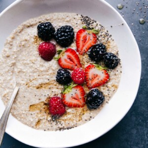 Finished breakfast dish topped with fresh berries, chia seeds, and honey, offering a warm and healthy start to the day.