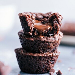 Stack of delectable brownie bites with luscious melted chocolate oozing from the center.