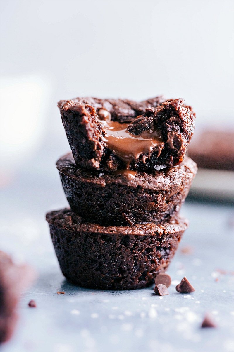 Stack of delectable brownie bites with luscious melted chocolate oozing from the center.