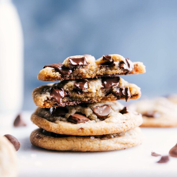 Small batch chocolate chip cookies stacked, with one cookie broken open revealing gooey, melting chocolate inside.