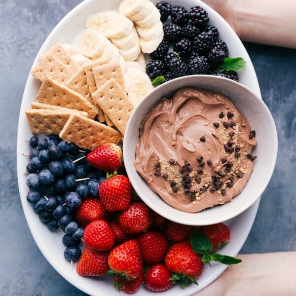 Chocolate dip for fruit with a variety of fresh berries, strawberries, bananas, and graham crackers.