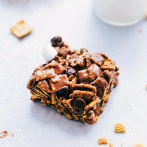 S'mores bar packed with chocolate chips and marshmallows, served alongside a glass of milk.