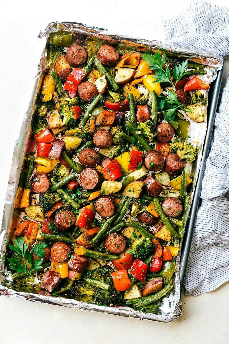 The sheet pan veggies and sausage on a foil-lined sheet pan, cooked to perfection and ready to be enjoyed.