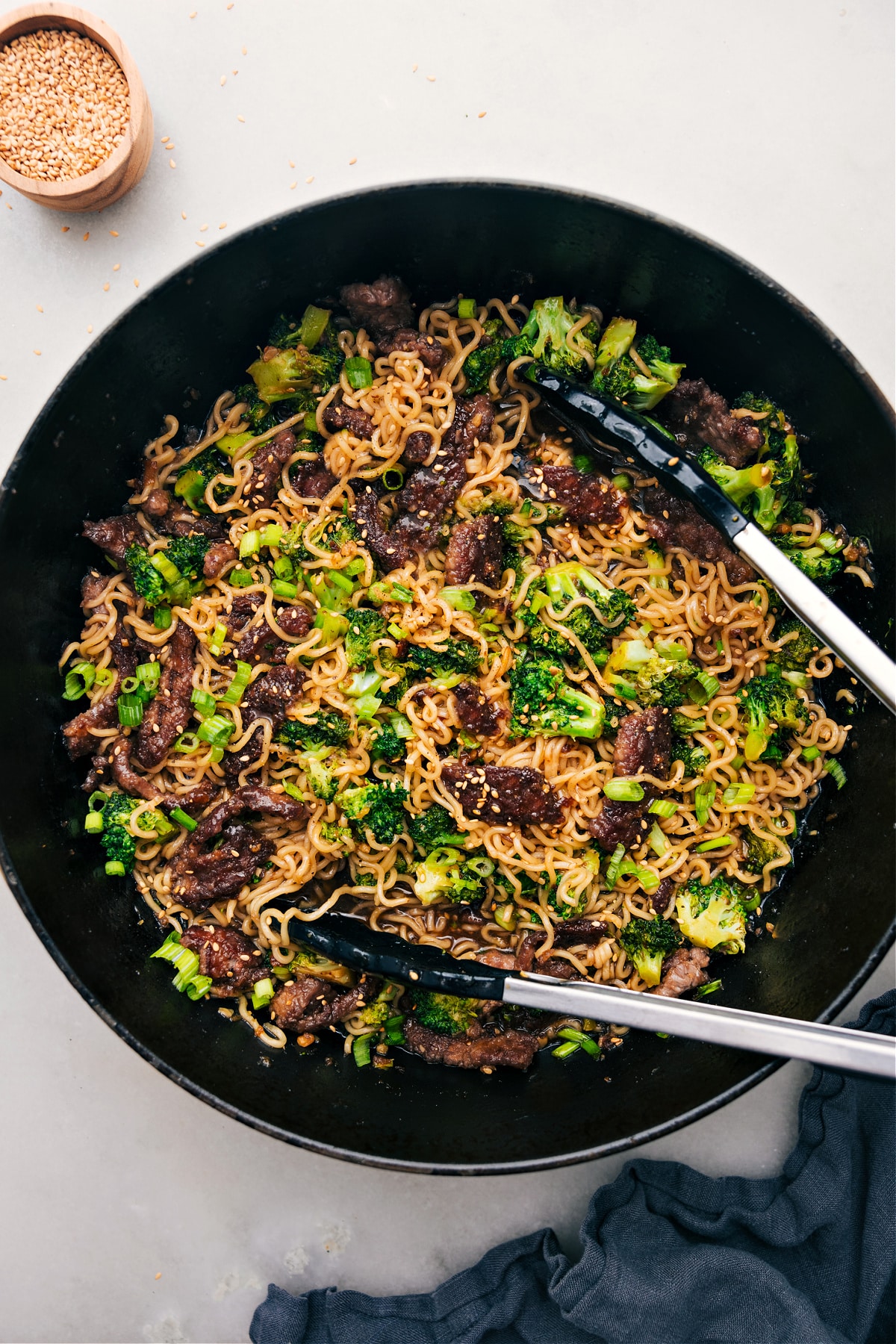 Beef and Broccoli Ramen in a pot, tongs ready to serve.