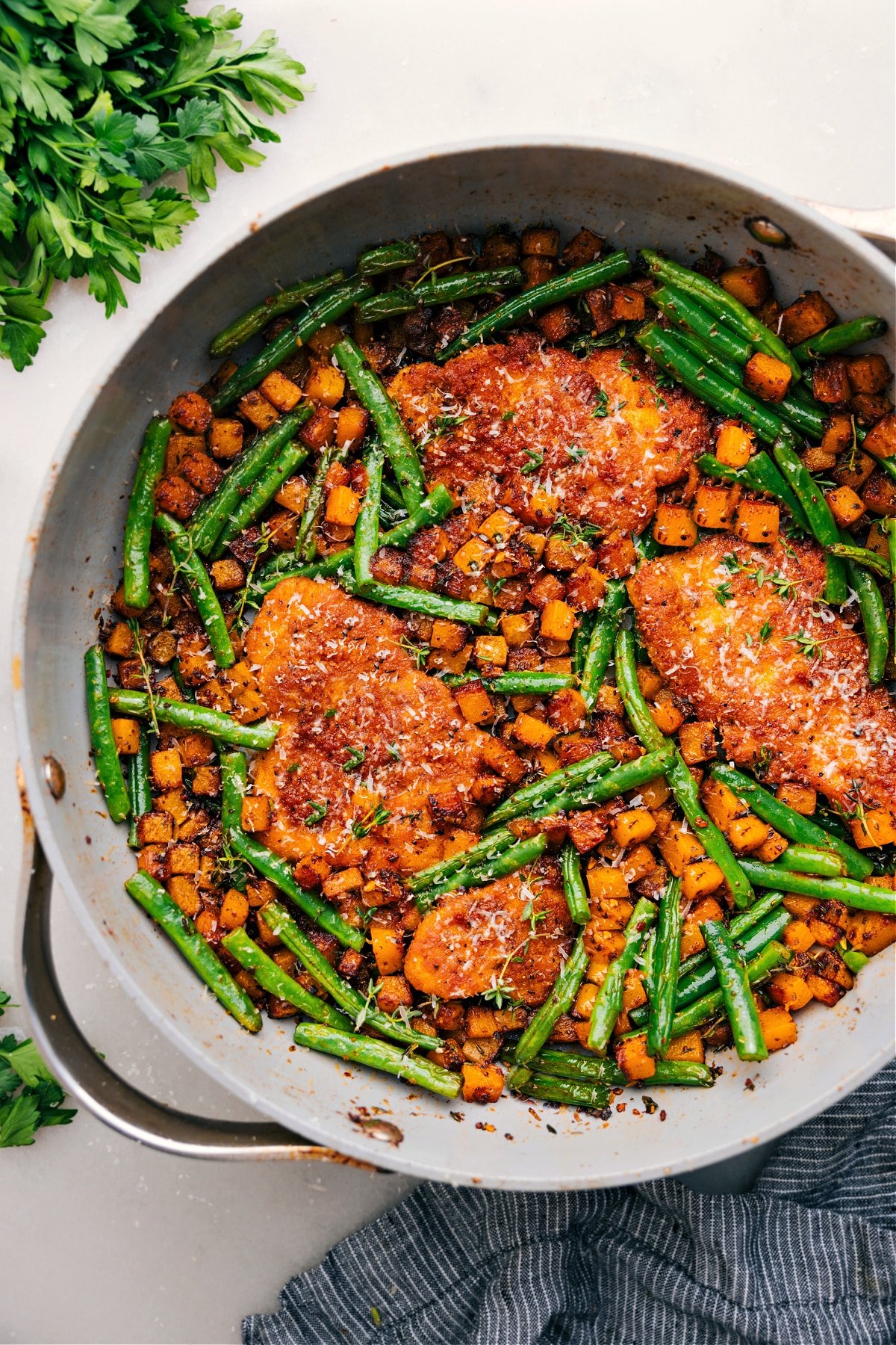 One skillet Chicken and Butternut Squash with fresh parmesan on top.