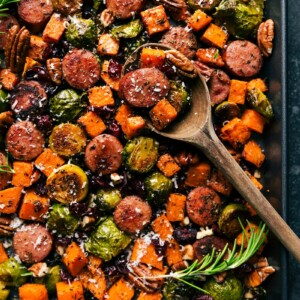 Tray of harvest vegetables and sausage, cooked and seasoned to perfection, ready to serve.