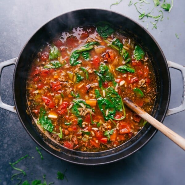 Warm and hearty italian sausage orzo soup in a pot, steaming and ready to be enjoyed.