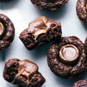 Mini brownie bites with rolos; one is cut in half to expose the gooey, melty insides.