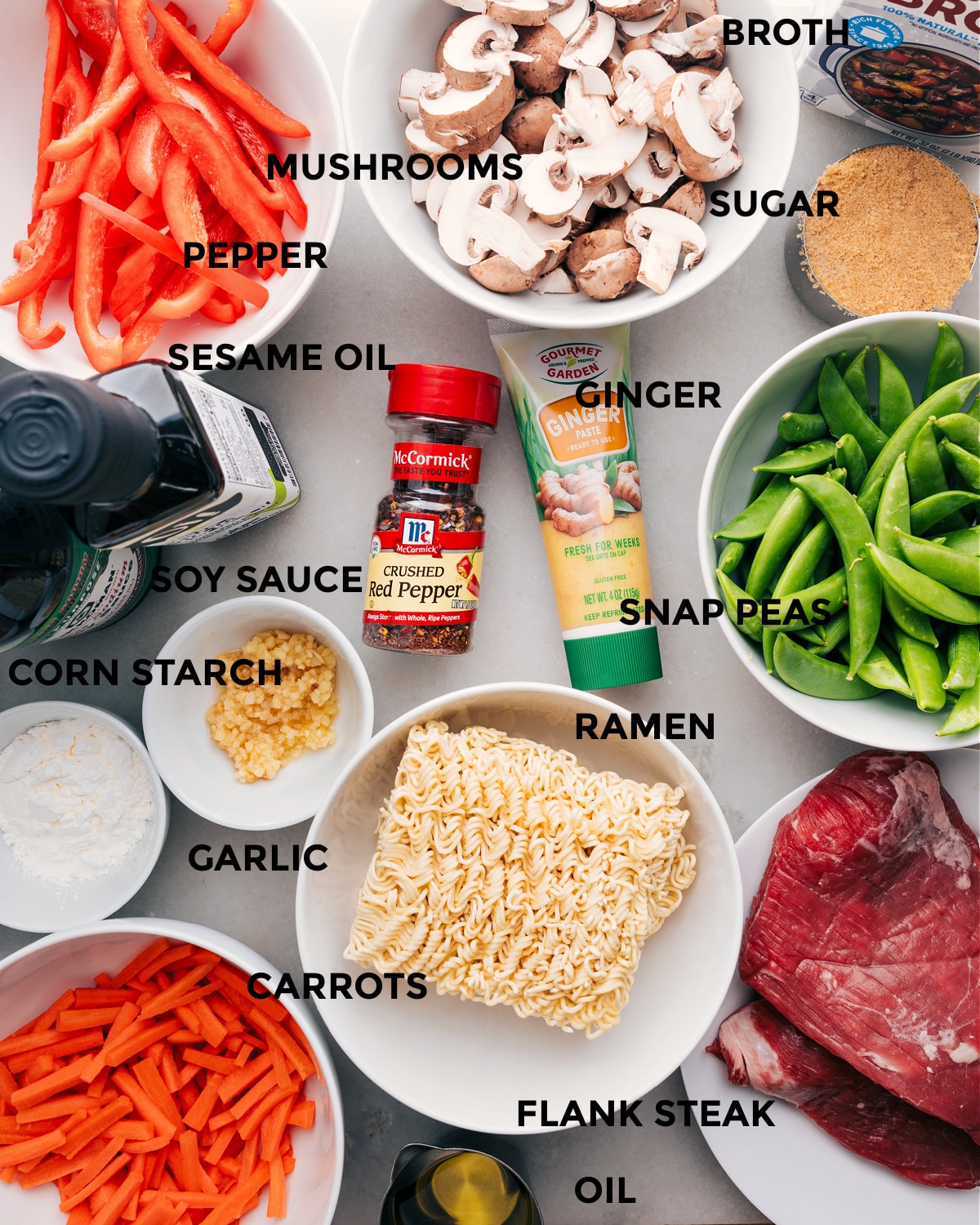 All the ingredients for this recipe, including the veggies, broth, sugar, noodles, cornstarch, garlic, seasonings, and meat, are prepped for easy assembly.