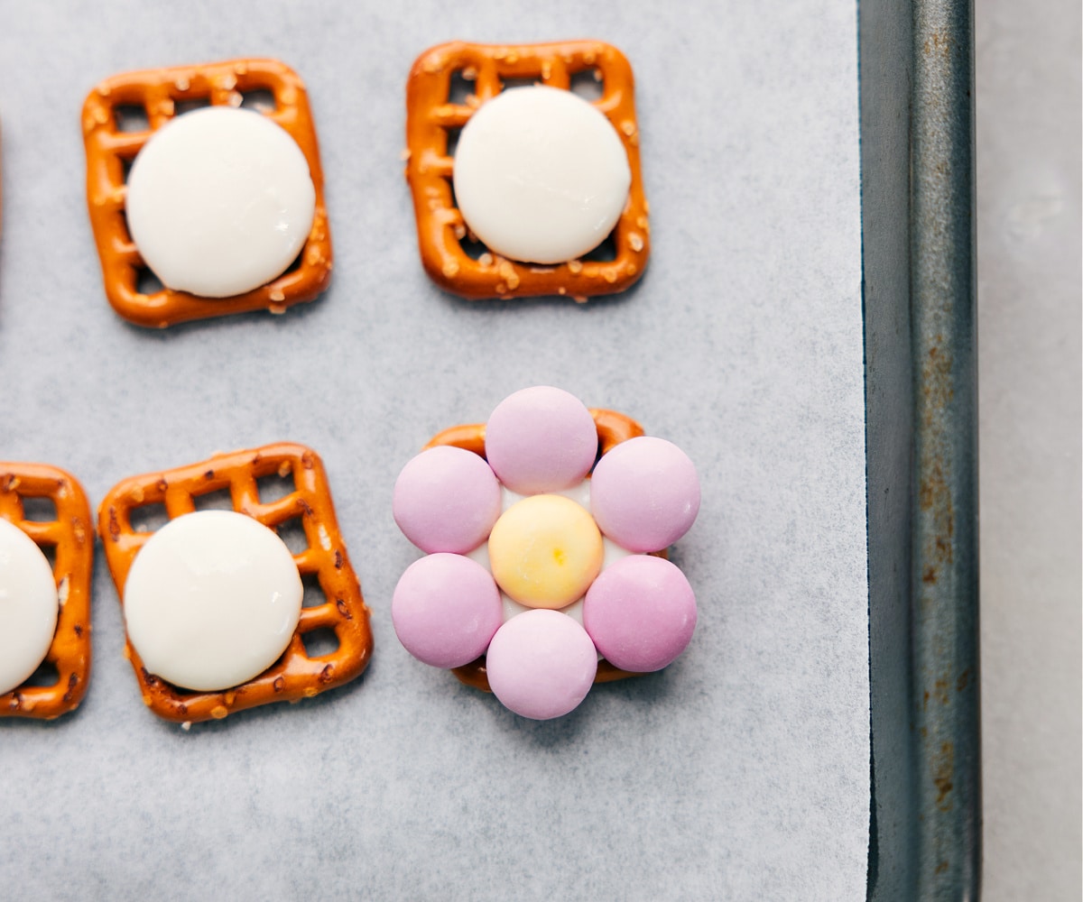 The M&M's placed on a pretzel to form a flower for these flower pretzels.