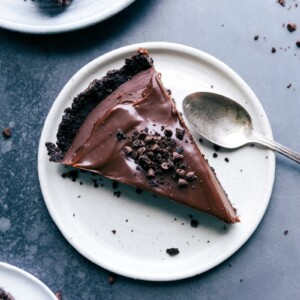 A slice of chocolate tart, a mouthwatering dessert topped with oreo crumbs, ready to be savored.