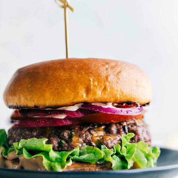 A mouthwatering burger created from this burger recipe, featuring a juicy patty sandwiched between soft buns, topped with a variety of delicious toppings.