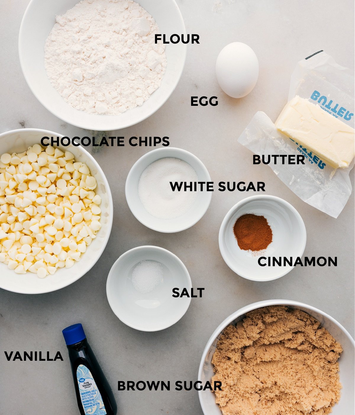 All the ingredients in the recipe including chocolate chips, egg, sugar, cinnamon, salt, butter, and flour, prepped out for easy assembly of this recipe.