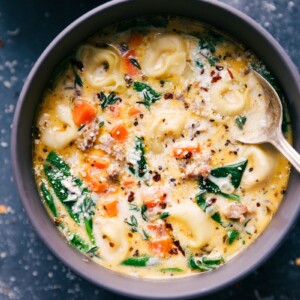 Sausage Tortellini Soup in a bowl with a spoon in it.