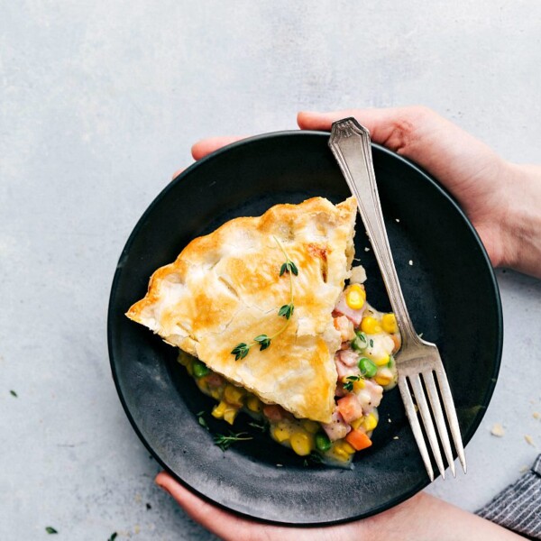 Holding a plate with this ham pot pie recipe.