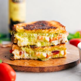 Caprese Grilled Cheese stacked on top of each other showing the cheesy center.