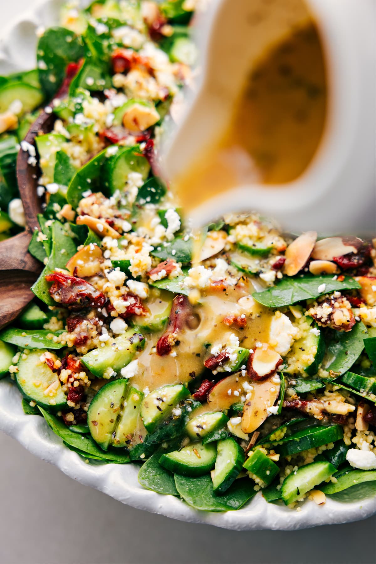 Dressing the Couscous Mediterranean Salad.