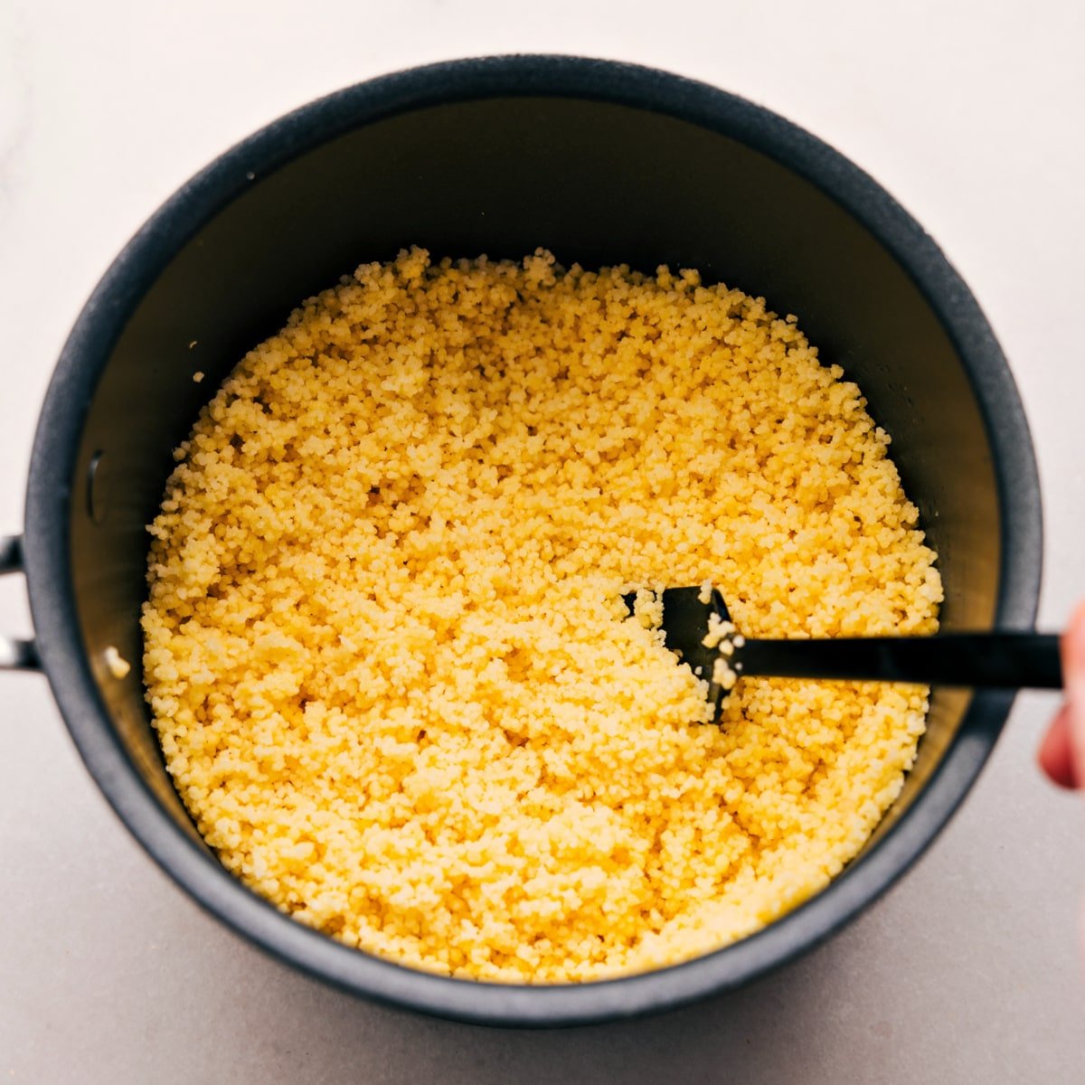 The couscous is prepped and fluffed in the pot, ready to add to the dish.