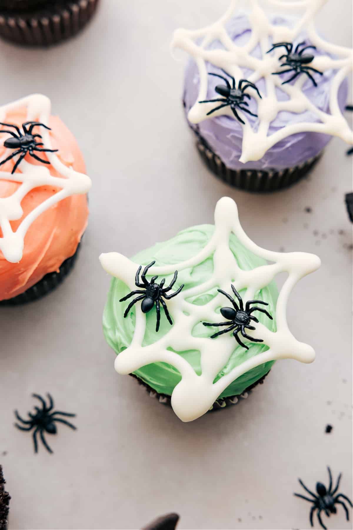 Spider web with fake spiders on colored frosting.