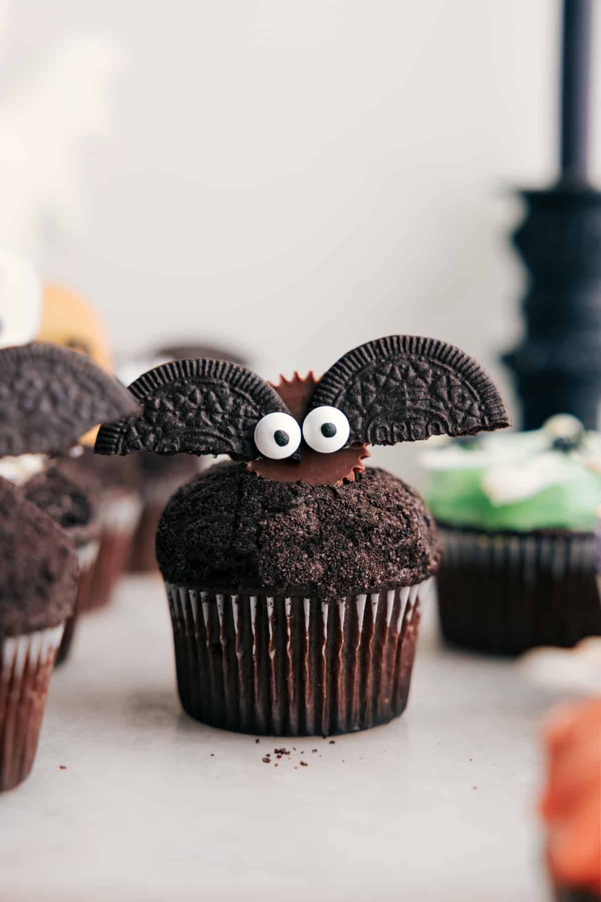 Bat Halloween Cupcakes made with mini Reese's, Oreos, and edible eyes.