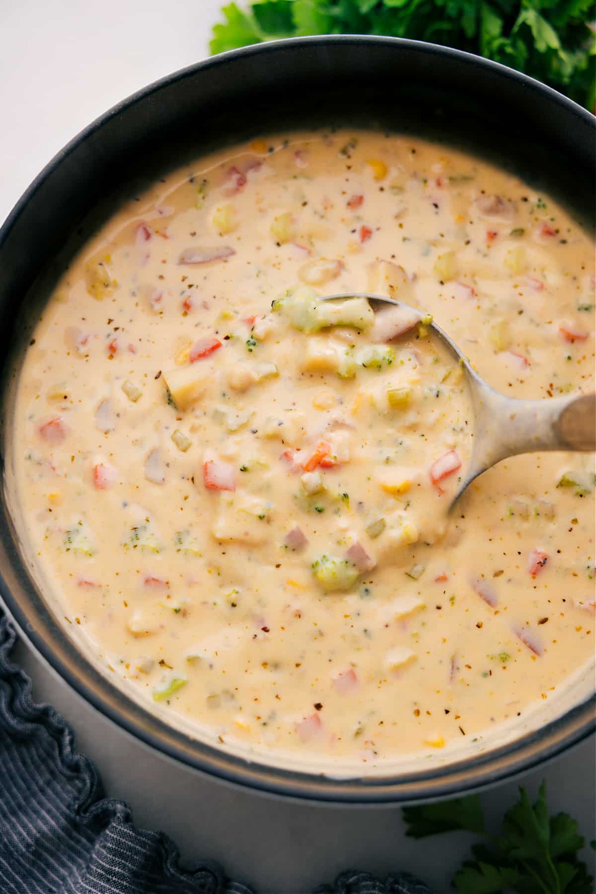 A pot of creamy vegetable soup with a ladle, ready to enjoy.