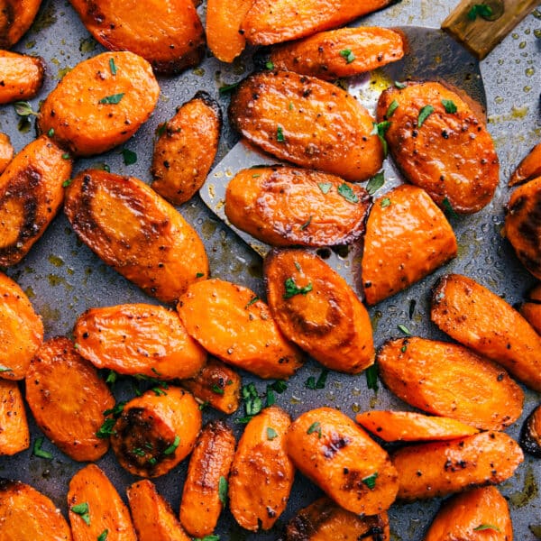 Pan of roasted and seasoned carrots with a golden, caramelized finish.