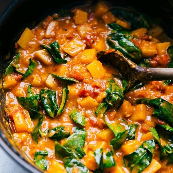 The finished curry butternut squash soup in the pot with fresh spinach added, warm and ready to be enjoyed.