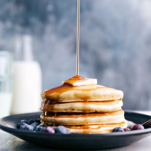 Syrup being poured over a stack of Greek Yogurt Pancakes.