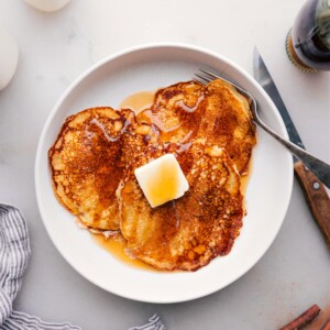 Delicious Stack of Pancakes Drizzled with Syrup on Plate