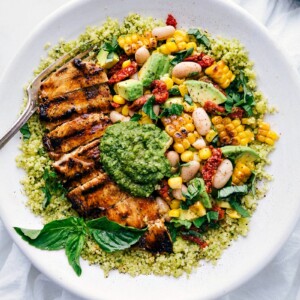 Pesto Chicken with chicken, corn and white bean salsa, and pesto on top.