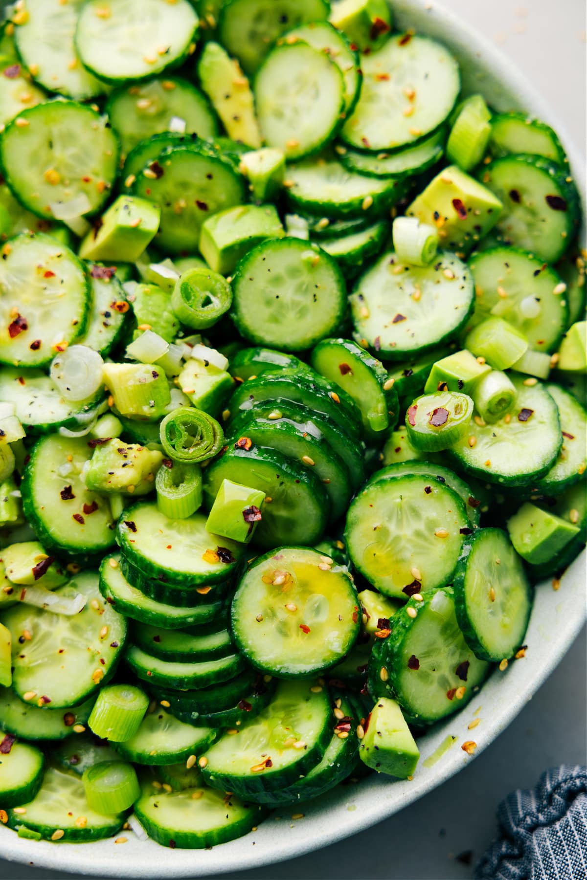 Asian Cucumber Salad in a bowl dressed and tossed together for a light side dish.
