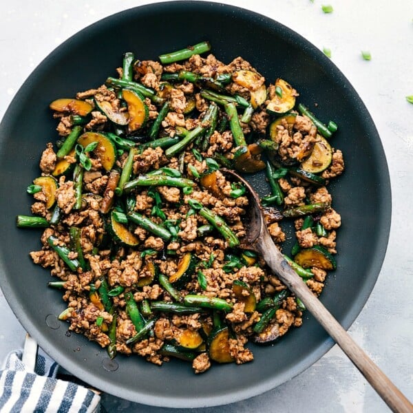 Pork stir fry sizzling in a skillet, seasoned to perfection and ready for a delightful meal.