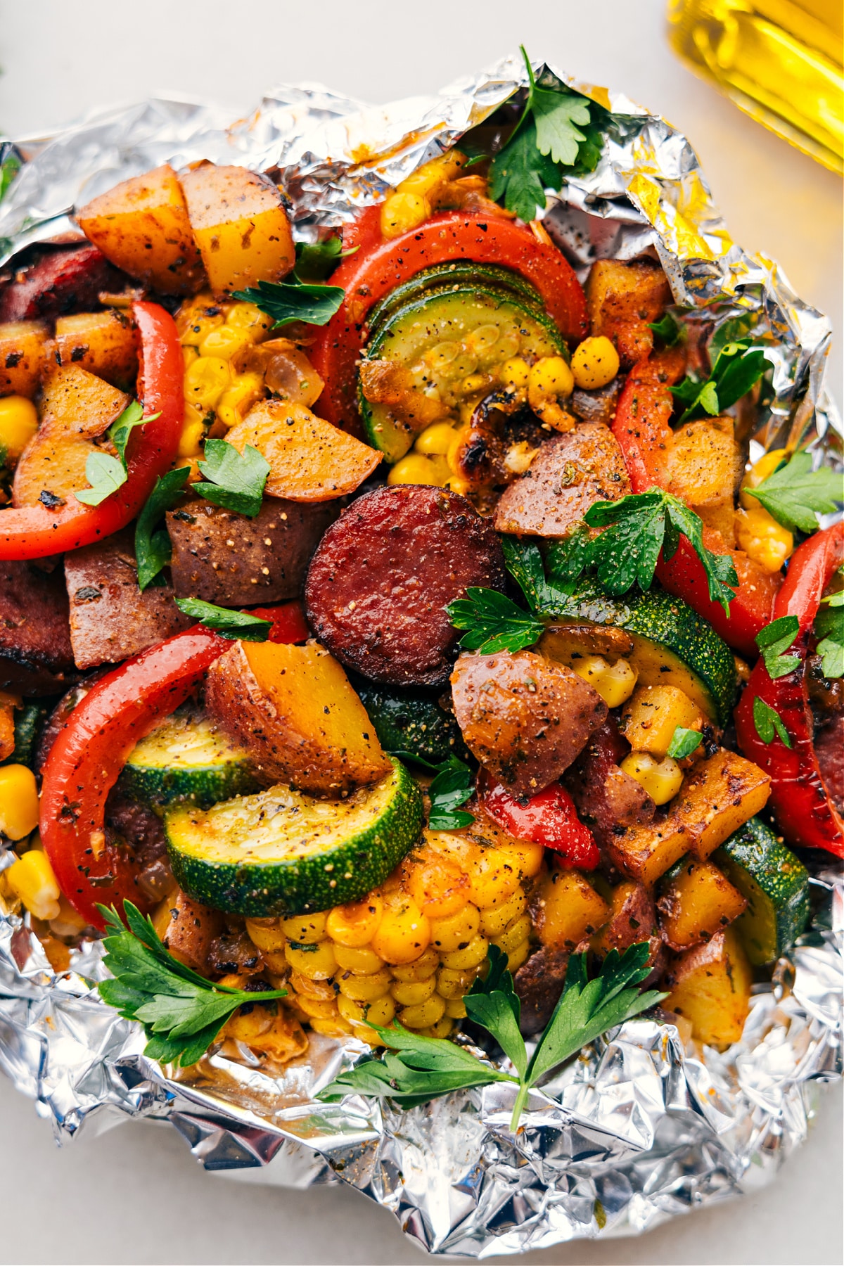 Tin Foil Sausage and Veggies Dinner ready to be eaten, the perfect camping or no mess meal.