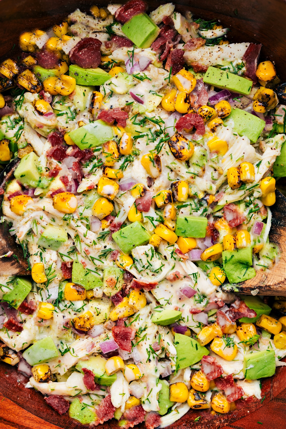 Avocado Chicken Salad in a bowl, dressed and tossed together, ready to be enjoyed.