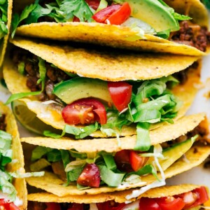 Delicious savory beef tacos in a casserole dish, fully assembled with all the toppings.