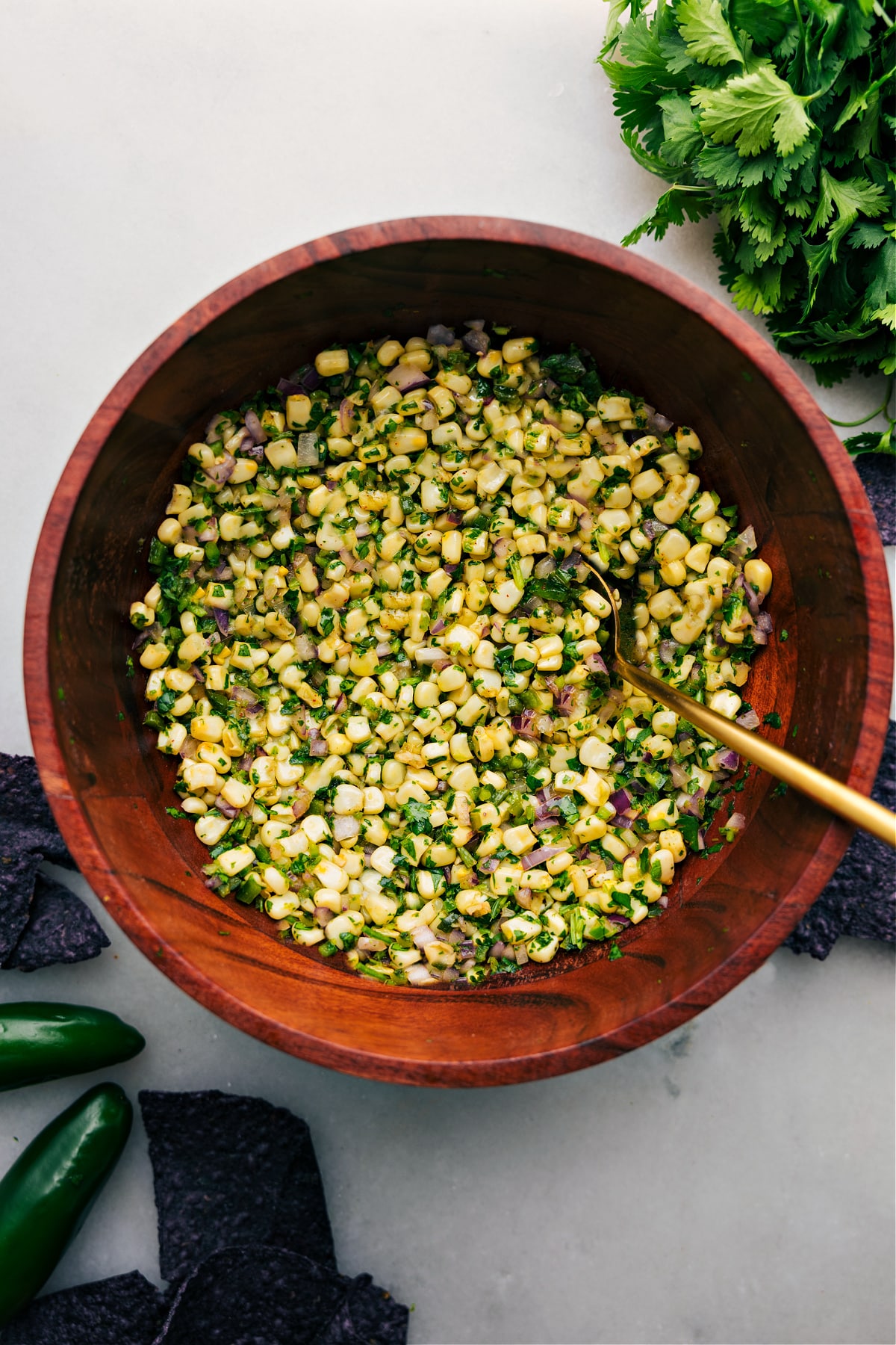 Chipotle Corn Salsa in a large bowl with spoon