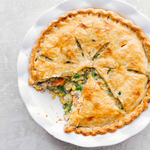 Homemade chicken pot pie recipe with a slice removed, showcasing a beautifully golden crust, ready to be savored.