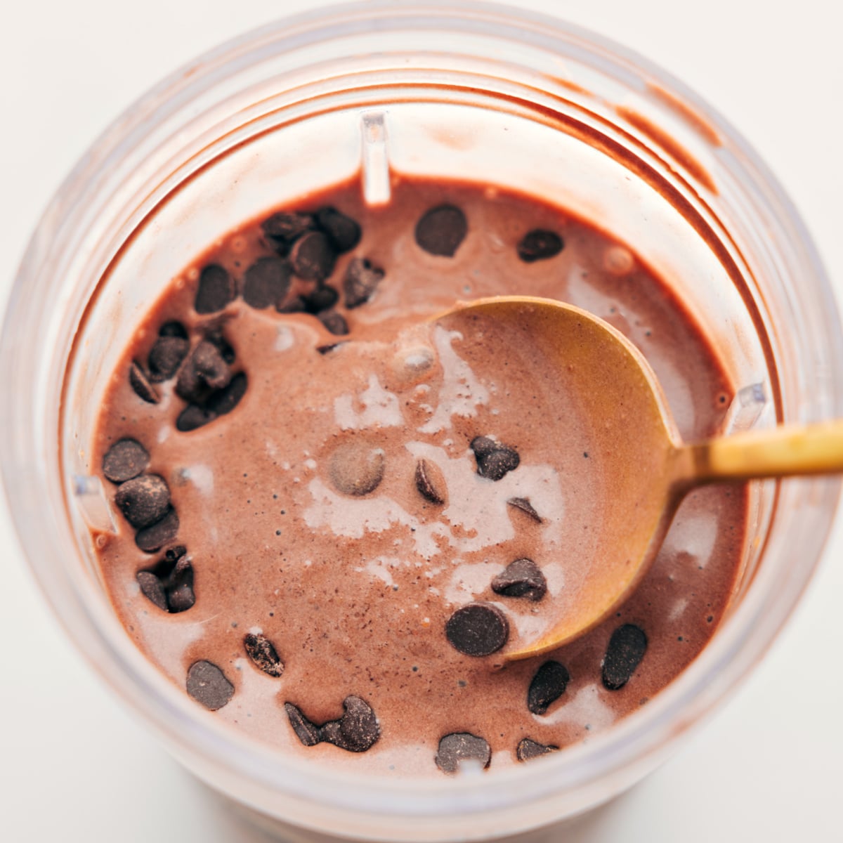 Spoonful of the delicious and creamy chocolate protein shake with chocolate chips on top for an extra delicious treat.