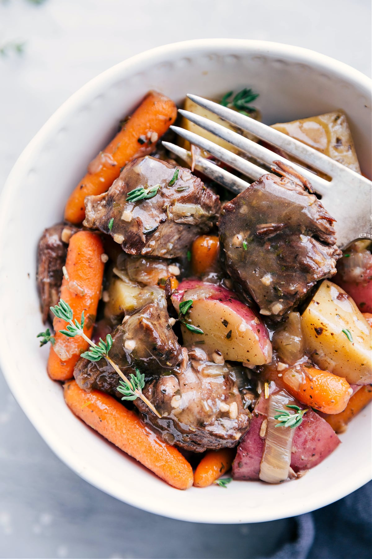 Serve the crockpot roast in a bowl, topped with gravy, and enjoy!