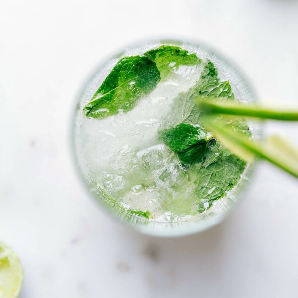 A refreshing virgin mojito topped with fresh mint leaves, served in a tall glass.