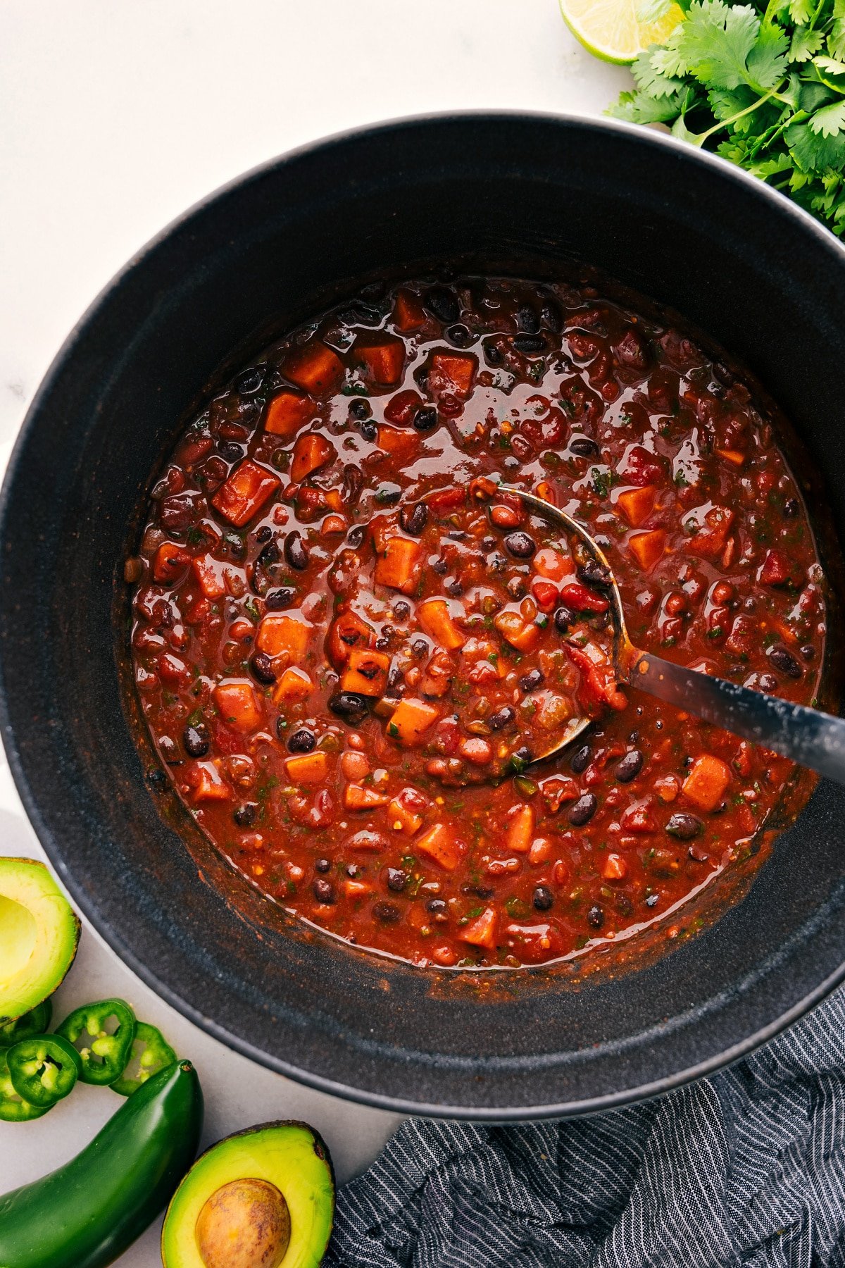 A big scoop of Sweet Potato Chili coming out of the pot.