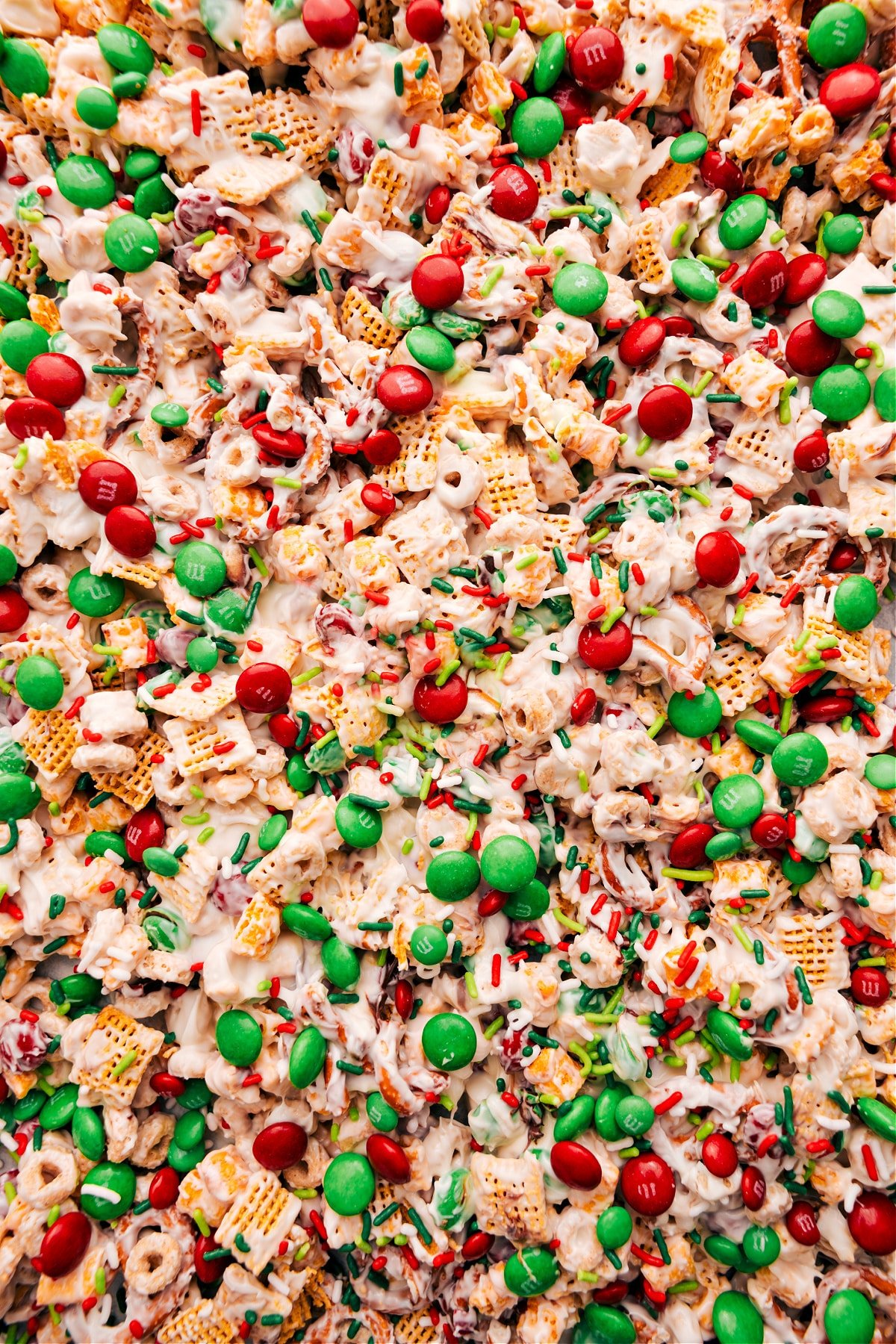 Christmas Snack Mix with sprinkles and M&Ms on top.