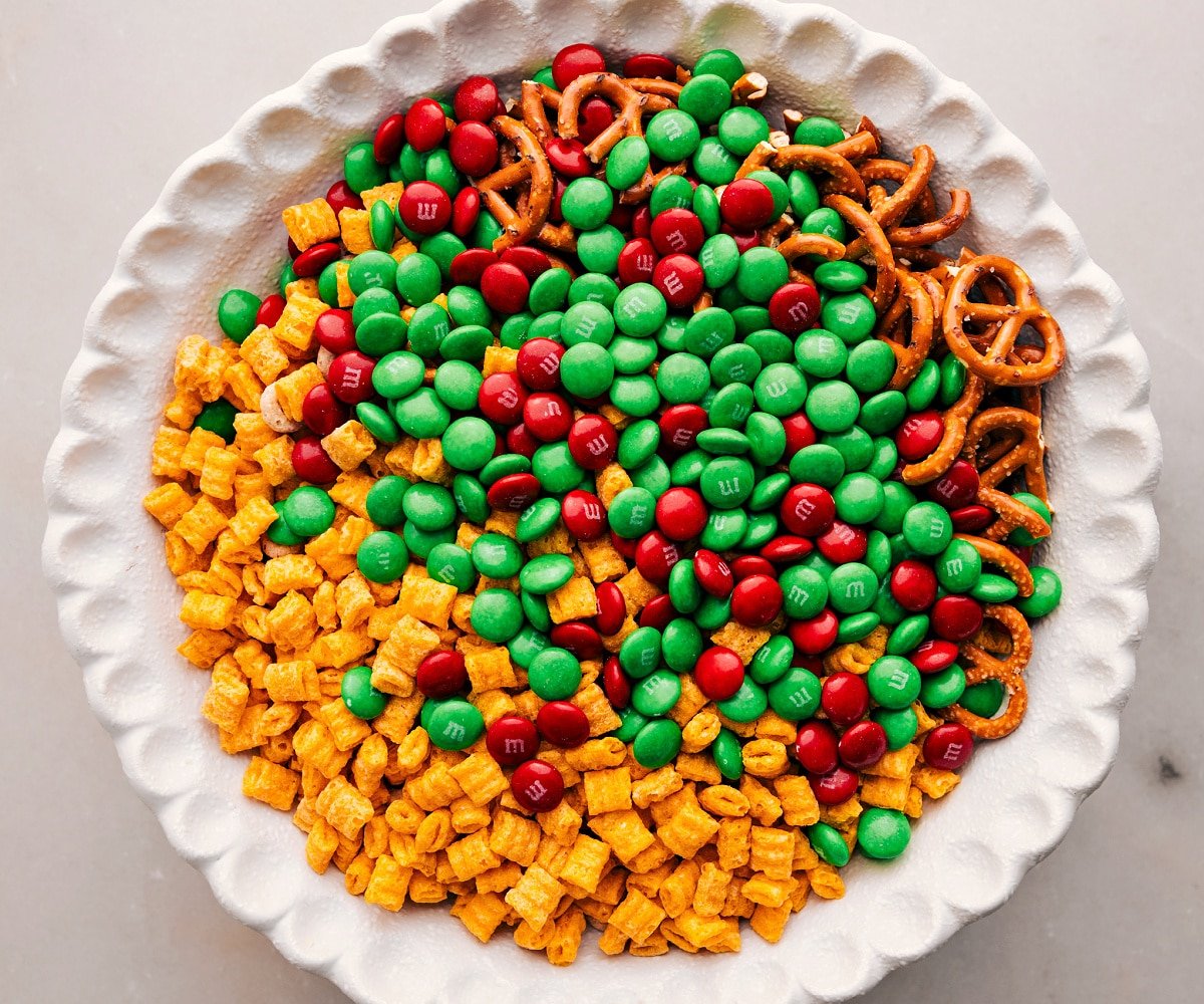 Add all the ingredients except the white chocolate to a bowl for the Christmas Snack Mix.