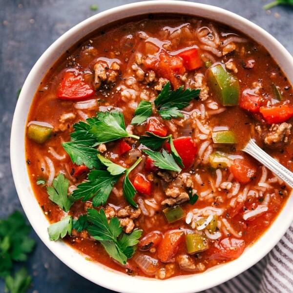 Bowl filled with hearty stuffed pepper soup, displaying colorful peppers, meat, and rice, ready for consumption.