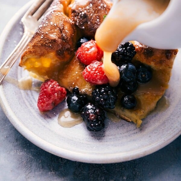 Buttermilk syrup cascading over a freshly baked dutch baby, creating a delectable contrast.